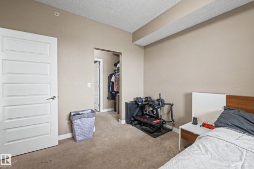 Bedroom featuring neutral-toned walls, recessed lighting, and carpet flooring - 402 8730 82 Avenue, Edmonton, AB 