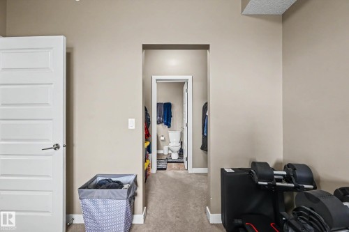 Neutral-toned walls complement the clean white trim and solid core interior door - 402 8730 82 Avenue, Edmonton, AB 