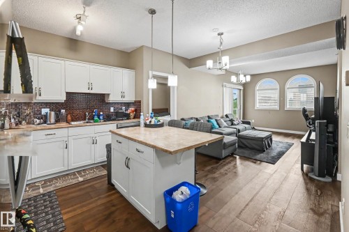 Open-concept kitchen and living area featuring wood-finish flooring - 402 8730 82 Avenue, Edmonton, AB 