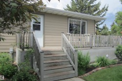 Elevated wood deck with railing accessed by exterior stairs - 