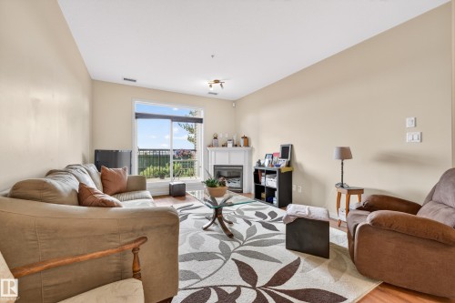 Living area with light beige walls and sloped ceilings - 133 2503 Hanna Crescent, Edmonton, AB 