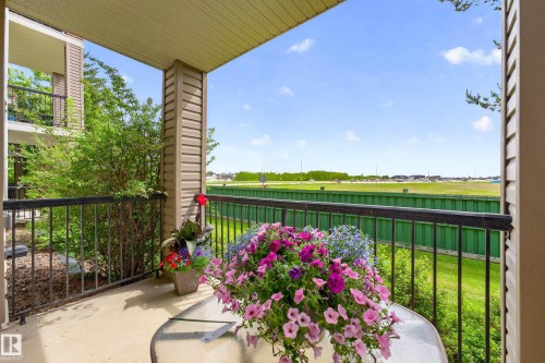 Private balcony featuring a concrete floor, black metal railing, and neutral-toned siding - 133 2503 Hanna Crescent, Edmonton, AB 