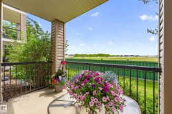 Private balcony featuring a concrete floor, black metal railing, and neutral-toned siding - 