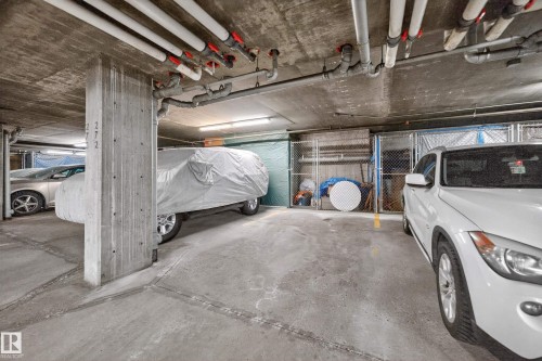 Concrete parking garage with exposed ceiling pipes and concrete support columns - 133 2503 Hanna Crescent, Edmonton, AB 