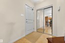 Foyer entryway featuring a white paneled door, mirrored closet doors, and tile flooring - 133 2503 Hanna Crescent, Edmonton, AB 