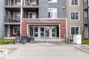 Modern multi-story building featuring a textured stone facade and horizontal siding - 101 107 Watt Common, Edmonton, AB 