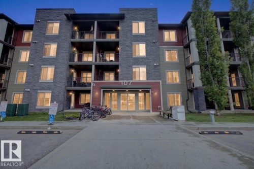 Contemporary multi-story building featuring stone veneer and panel siding - 101 107 Watt Common, Edmonton, AB 