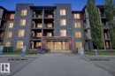 Contemporary multi-story building featuring stone veneer and panel siding - 101 107 Watt Common, Edmonton, AB 