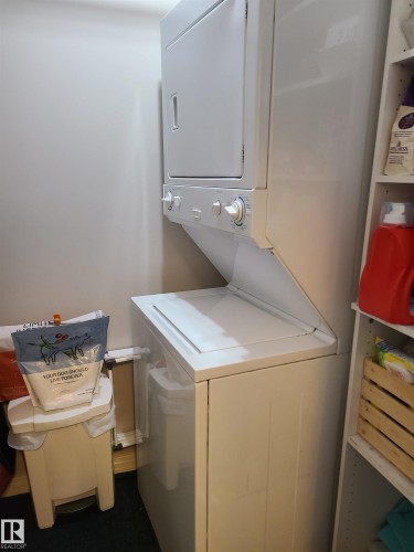 White stacked washer and dryer unit with top-load washer and front-load dryer - 116 5005 165 Avenue, Edmonton, AB 