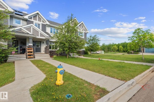 Townhome exterior with a multi-gabled roofline and a combination of horizontal siding and shake siding - 12809 203A, Edmonton, AB 