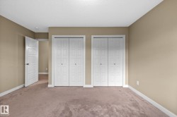Neutral-toned wall paint and plush carpeting create a comfortable atmosphere - 