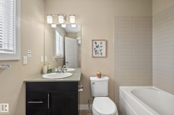 Vanity with dark wood-finish cabinetry, a light-toned countertop, and an undermount sink - 