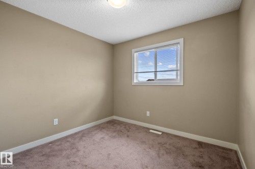 Room with neutral tone walls, brown carpeting, and white baseboards - 12809 203A, Edmonton, AB 