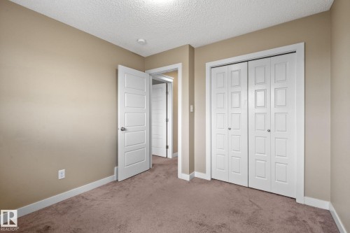 Carpeted room featuring neutral wall paint and white trim - 12809 203A, Edmonton, AB 
