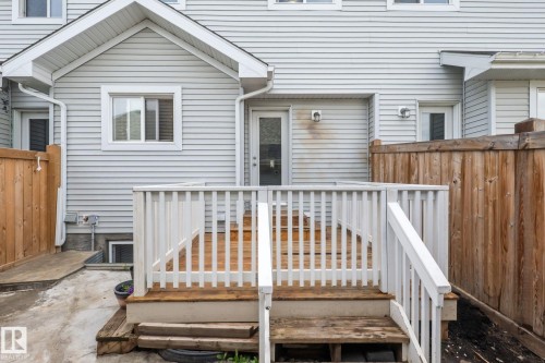 Rear exterior featuring wood deck with white railings and stairs - 12809 203A, Edmonton, AB 