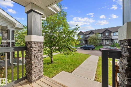 Front porch with wood-finish decking and stone veneer accent pillars - 12809 203A, Edmonton, AB 