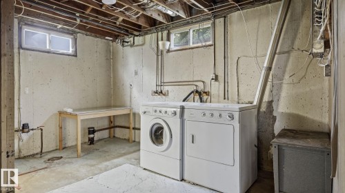 Utility area featuring concrete flooring, exposed ceiling joists, and two window openings - 13008 105 Street Nw, Edmonton, AB 