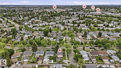 Aerial perspective of a residential neighborhood featuring numerous detached homes with mature trees and paved streets - 13008 105 Street Nw, Edmonton, AB 