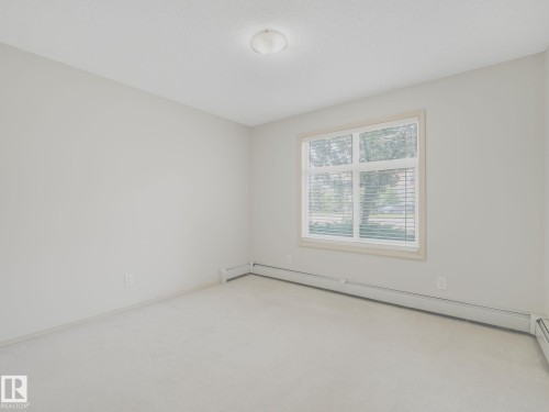 Neutral-toned wall paint and carpeting throughout - 117 6070 Schonsee Way, Edmonton, AB 