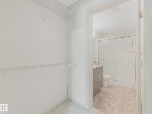 Walk-in closet with white wire shelving - 117 6070 Schonsee Way, Edmonton, AB 