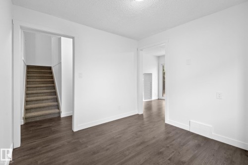Interior space featuring wood-finish flooring, white walls, and bright overhead lighting - 2832 135 Avenue, Edmonton, AB - Indoor Photo Showing Other Room