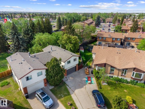 Aerial property perspective featuring a neutral-toned roof, mature perimeter trees, and established residential landscaping - 2832 135 Avenue, Edmonton, AB - Outdoor With View
