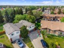 Aerial property perspective featuring a neutral-toned roof, mature perimeter trees, and established residential landscaping - 2832 135 Avenue, Edmonton, AB  - Outdoor With View 