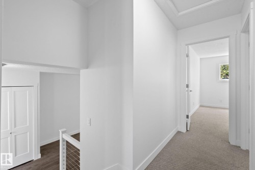 Hallway featuring neutral-toned carpeting and white trim - 2832 135 Avenue, Edmonton, AB - Indoor Photo Showing Other Room