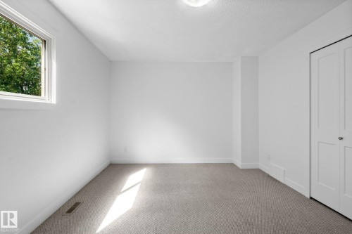 Carpeted room featuring white walls, a single window with white trim, and a bi-fold closet door - 2832 135 Avenue, Edmonton, AB - Indoor Photo Showing Other Room