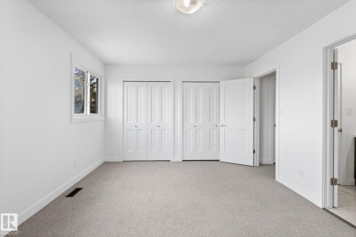 Neutral-toned carpet flooring complementing white walls and trim - 2832 135 Avenue, Edmonton, AB - Indoor