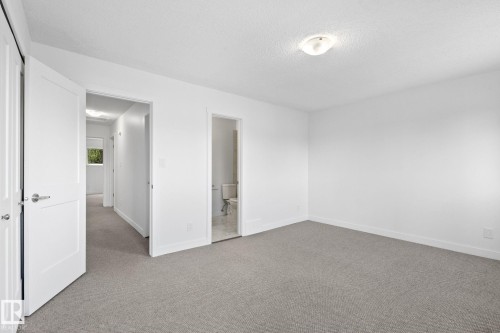 Carpeted room featuring white walls, white trim, and a ceiling-mounted light fixture - 2832 135 Avenue, Edmonton, AB - Indoor Photo Showing Other Room
