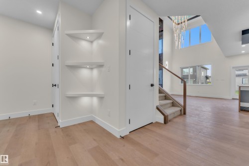 Hardwood-finish flooring extending into the open-concept living space - 3602 44 Avenue, Beaumont, AB 
