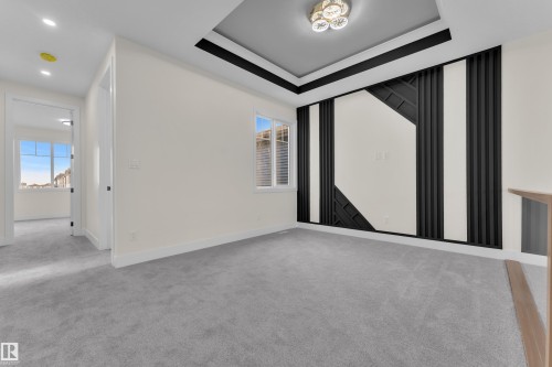 Contemporary accent wall featuring black paneling and geometric design elements - 3602 44 Avenue, Beaumont, AB 