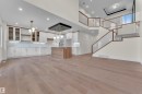 Expansive open-concept living area featuring wide-plank wood-finish flooring - 3602 44 Avenue, Beaumont, AB 