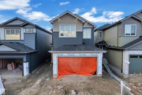 Two-story residence featuring a blue and grey exterior with board and batten and shingle siding accents - 3602 44 Avenue, Beaumont, AB 