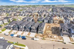 Aerial perspective showcasing a residential development with numerous single-family homes under construction and completed - 