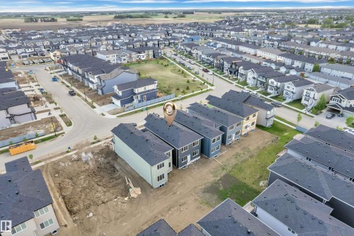 Modern multi-story residential properties featuring dark shingled roofs and light-colored siding - 3602 44 Avenue, Beaumont, AB 