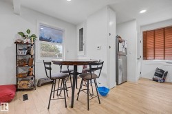 Bright room featuring light wood-finish flooring, recessed ceiling lighting, and a white framed window - 