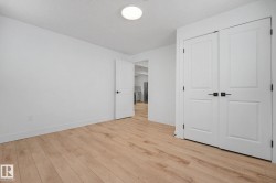 Room featuring light wood-finish flooring and white walls - 