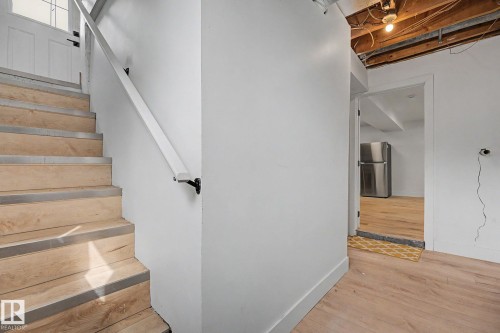 Staircase with wood-finish treads and metal nosings - 11914 124 Street, Edmonton, AB 