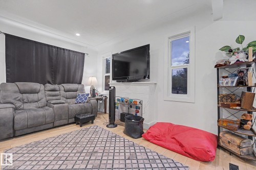 Living area featuring light wood-finish flooring and recessed lighting - 11914 124 Street, Edmonton, AB 
