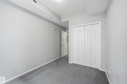 Room featuring light gray walls and gray carpeting - 