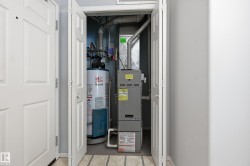 Dedicated utility closet containing a hot water heater and furnace system - 