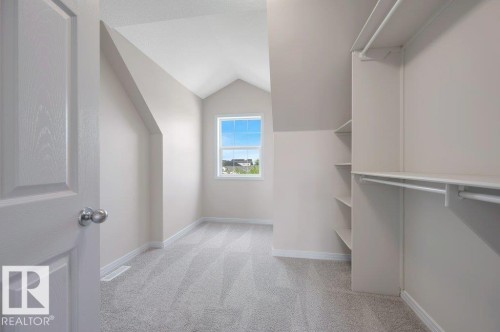 Room featuring a vaulted ceiling, light gray carpeting, and a double-hung window - 14 4367 Veterans Way, Edmonton, AB 