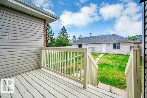 Rear deck with painted wood-finish flooring and matching railing - 14 4367 Veterans Way, Edmonton, AB 