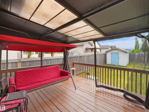 Covered wood deck with dark railings - 2418 32B Street, Edmonton, AB 