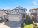 Two-story residence featuring light-colored siding and a gabled roofline - 2418 32B Street, Edmonton, AB 