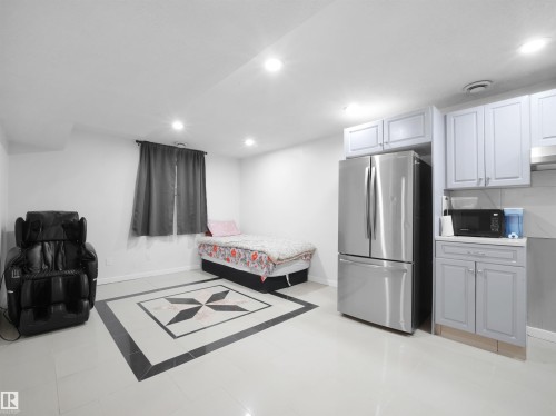 Open concept space featuring light tile flooring with a decorative inlay - 2418 32B Street, Edmonton, AB 