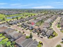 Suburban neighborhood featuring a landscaped retention pond with surrounding green spaces - 2418 32B Street, Edmonton, AB 