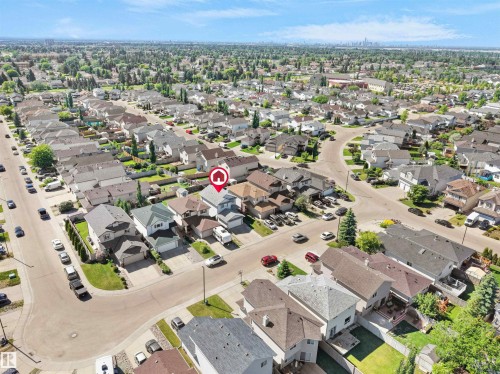 Residential neighborhood featuring varied single-family homes with mature trees and paved streets - 2418 32B Street, Edmonton, AB 